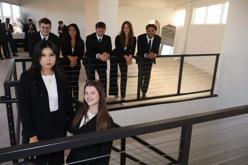 RAD team members gathered on the office staircase and mezzanine