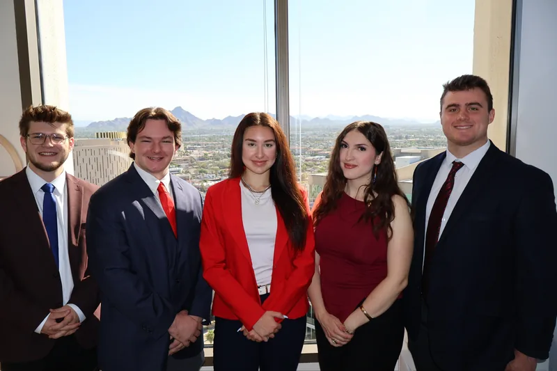Five RAD team members in front of the Phoenix city view