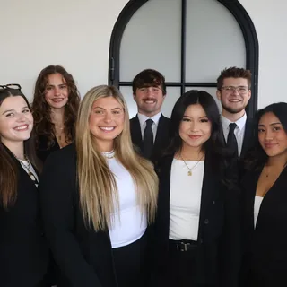 RAD team members together in front of the arched office window
