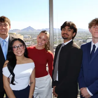 RAD team members in front of the office window with mountain views