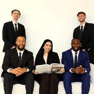 RAD team members seated together reviewing a magazine
