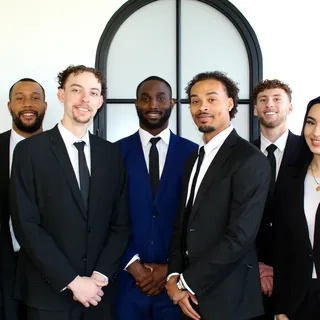 RAD team members together by the arched office window
