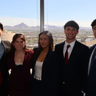 Five RAD team members in front of the Phoenix skyline